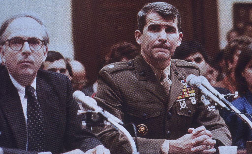 Photo of Oliver North on the stand refusing to testify before Congress.